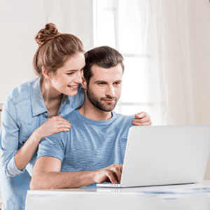 Two people discussing laptop screen- Moss Bollinger LLP