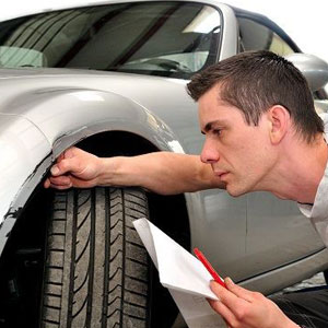 A man inspecting a car- Moss Bollinger LLP