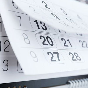 A close-up of a calendar showing dates from 20 to 28. Spiral-bound pages with bold numbers- Moss Bollinger LLP