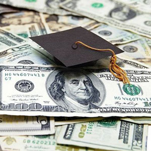 A graduation cap on a pile of US dollars- Moss Bollinger LLP