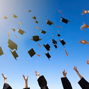 Graduates celebrating their achievement by joyfully tossing their caps into the air- Moss Bollinger LLP