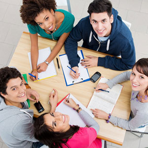 A diverse group of students sitting around a table- Moss Bollinger LLP