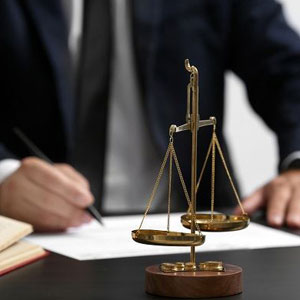 A professional man in a suit writing on a piece of paper- Moss Bollinger LLP