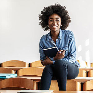 A woman sits on a chair, fully engaged in the educational session- Moss Bollinger LLP