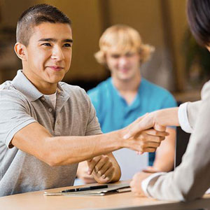 A young man shaking hands with another- Moss Bollinger LLP