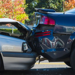 Two damaged cars after a collision, showing visible dents and broken parts- Moss Bollinger LLP