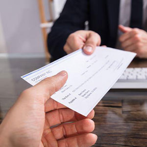 A man handing a check to another man- Moss Bollinger LLP