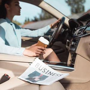A woman driving a car on her way to work- Moss Bollinger LLP
