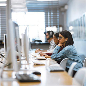 A diverse team of professionals working in an office, focused and engaged in their tasks- Moss Bollinger LLP