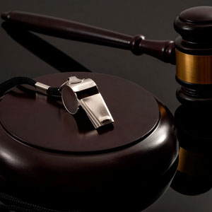 A judge's gavel and whistle on a black background - Moss Bollinger LLP