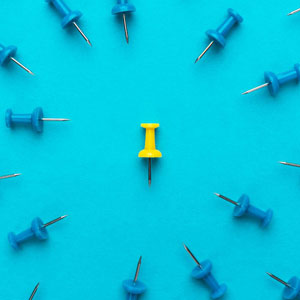 single yellow pin placed at the center of a circular arrangement of blue pins - Moss Bollinger LLP