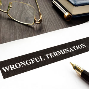 Wrongful termination document on a table. a pen & glasses lie next to the document - Moss Bollinger LLP