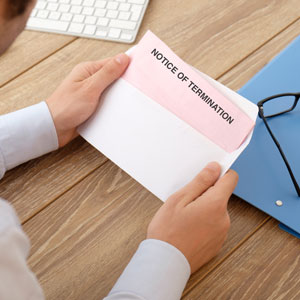 A man holding a termination notice - Moss Bollinger LLP