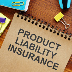 A desk with office supplies, featuring product liability insurance documents. - Moss Bollinger LLP